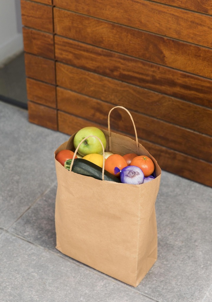 A grocery paper bag full of fruits