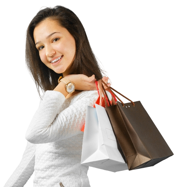 A smiling girl holding paper bags on her shoulder